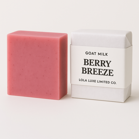 Pink bar of soap next to its white packaging with 'Berry Breeze' and 'Lola Luxe Limited Co.' text on a light background.