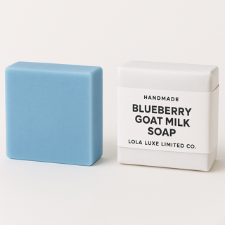 Blue bar of soap next to its packaging on a white background