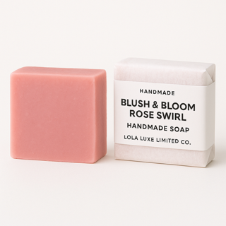 Pink handmade soap bar with packaging labeled 'Blush & Bloom Rose Swirl' on a white background