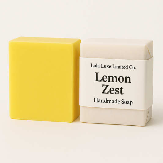 Yellow handmade soap bar next to its packaging with 'Lola Luxe Limited Co.' branding on a white background.