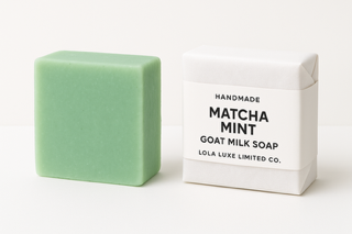 Green soap bar and packaging with 'Matcha Mint' text on a white background