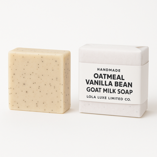 Bar of oatmeal vanilla bean goat milk soap next to its packaging on a white background