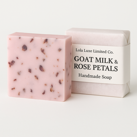 Bar of soap with goat milk and rose petals next to its packaging on a white background