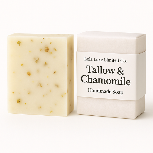 Handmade soap bar with chamomile pieces next to its packaging box on a white background